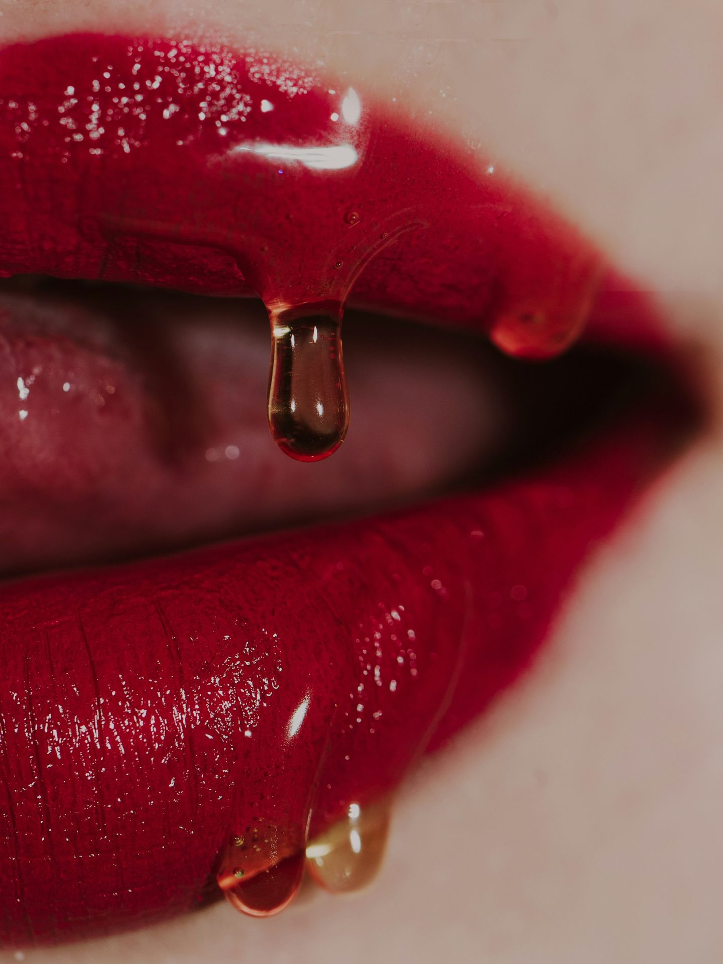 a close up of a woman's lips with a drop of liquid