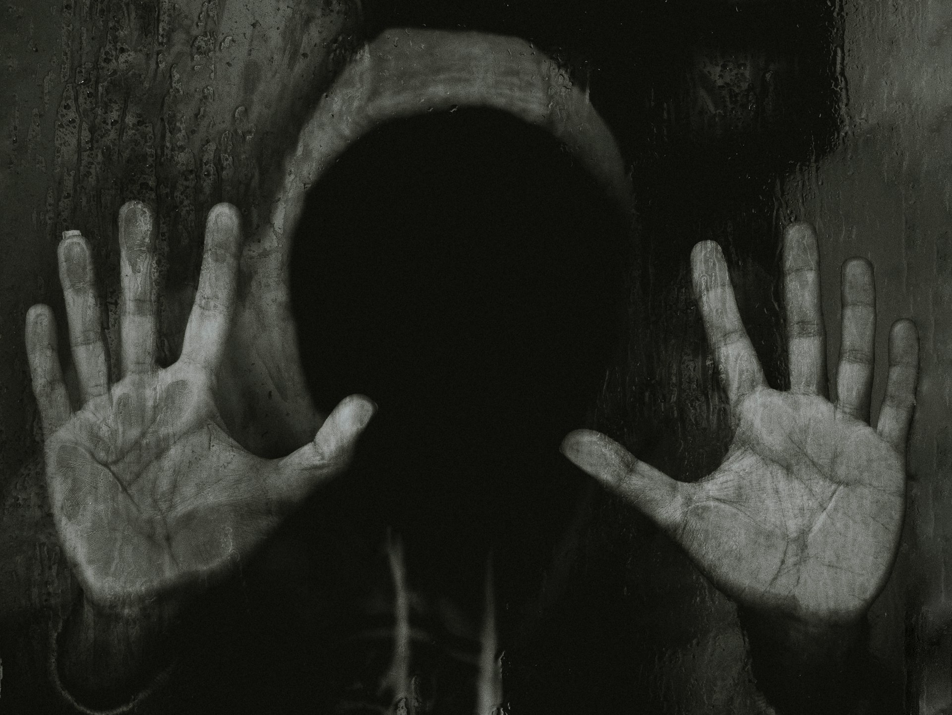 a person with their hands in the dark
